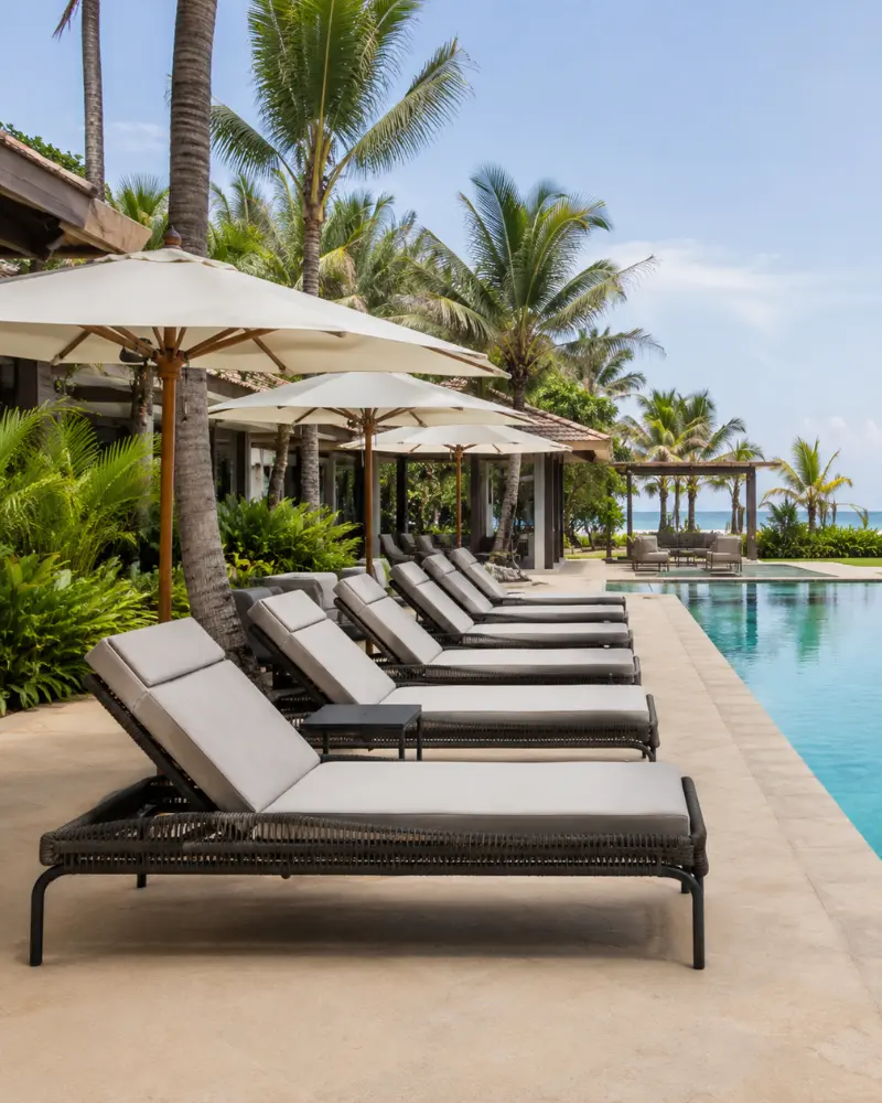 Powder-coated marine-grade aluminium outdoor dining sets and poolside loungers arranged at a luxury resort in Goa