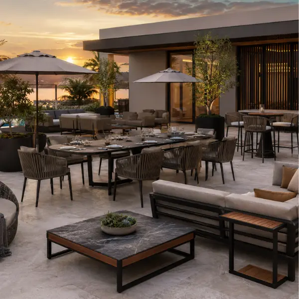 Complete poolside furniture setup including daybeds and side tables at a coastal hotel property.
