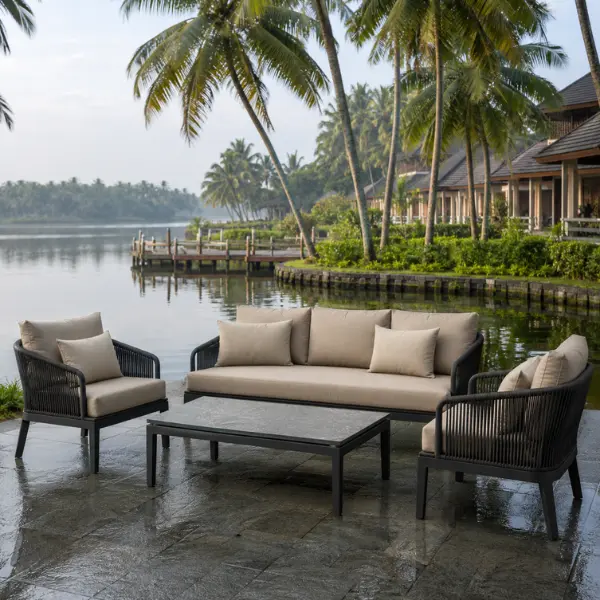 Luxury backwater resort outdoor furniture in Kochi, showcasing moisture-resistant synthetic rattan seating next to the water.