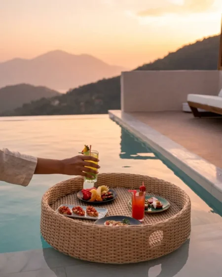 The Amalfi Float Round Rattan Tray featuring a classic circular silhouette, sturdy handles, and honey waterproof PE rattan over an aluminum core.