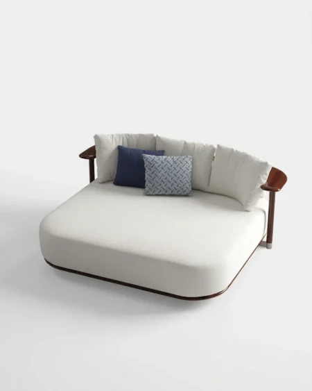 Luxury Belmont sculpted-arm indoor daybed featuring a kiln-dried solid wood frame in a walnut finish, manufactured for high-end resorts.