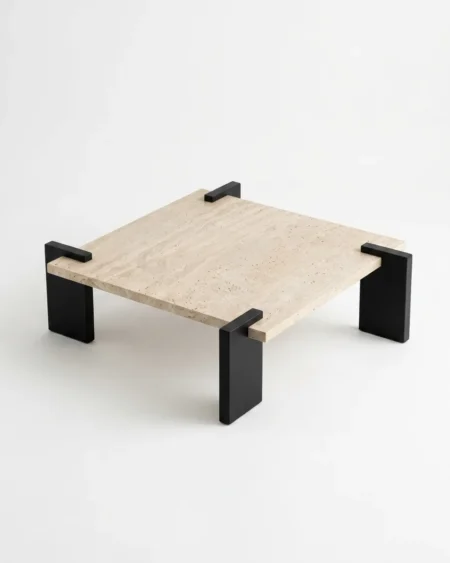 The Brutus Travertine Center Table featuring a massive square natural stone top and brutalist black metal block legs.