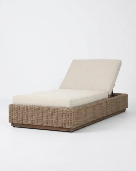 Luxury Camden wicker sun lounger featuring an architectural wood-grain aluminium base and UV-stabilized natural synthetic rattan, manufactured for high-end resorts.