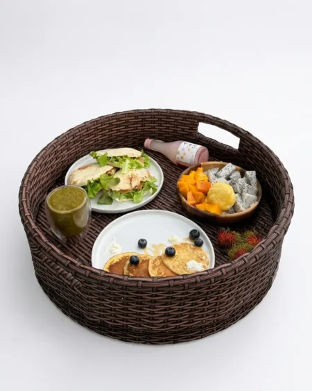 The Cascade round weave serving tray featuring commercial grade UV-stabilized rattan weaving over a rust-proof aluminum frame.