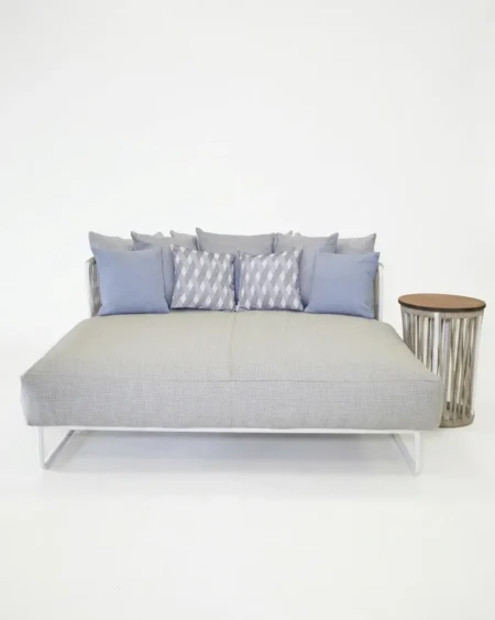 Luxury Everly loop-frame outdoor daybed featuring a rust-proof white aluminium frame and textured scatter cushions, manufactured for high-end resorts.