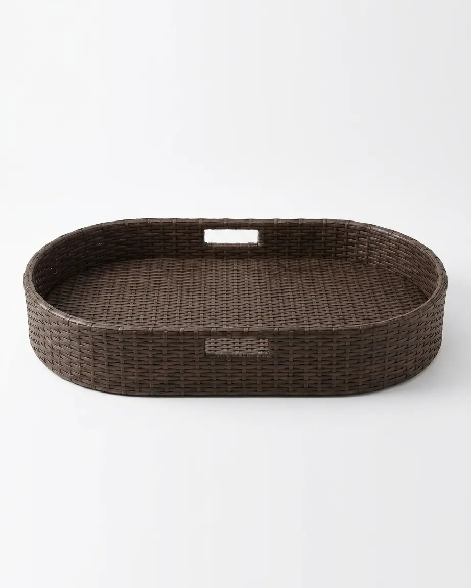 The Marbella Oval Weave Serving Tray featuring a sweeping curved silhouette and dark UV-stabilized PE rattan over rust-proof aluminum.