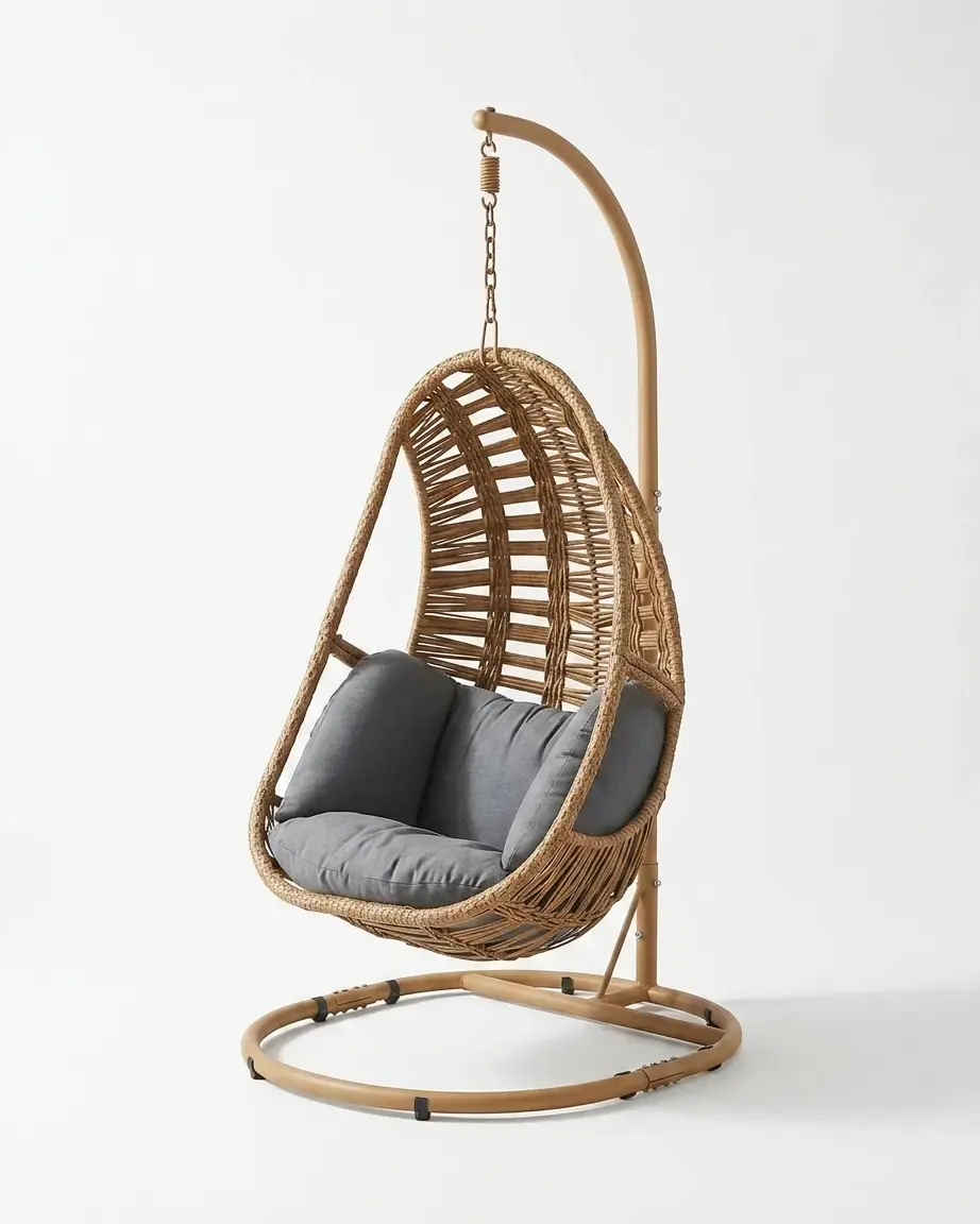 The Marbella Wicker Egg Swing Chair featuring a tan woven rattan cocoon and a rust-proof powder-coated stand.