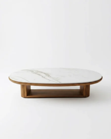 The Nordvik Center Table featuring a premium oval Calacatta marble top resting on a Scandinavian style solid teak wood frame with an integrated shelf.