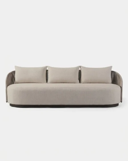 The Ovalis Curved Plinth Sofa featuring a sophisticated 3-seater design with an oval dark base and beige cushions.