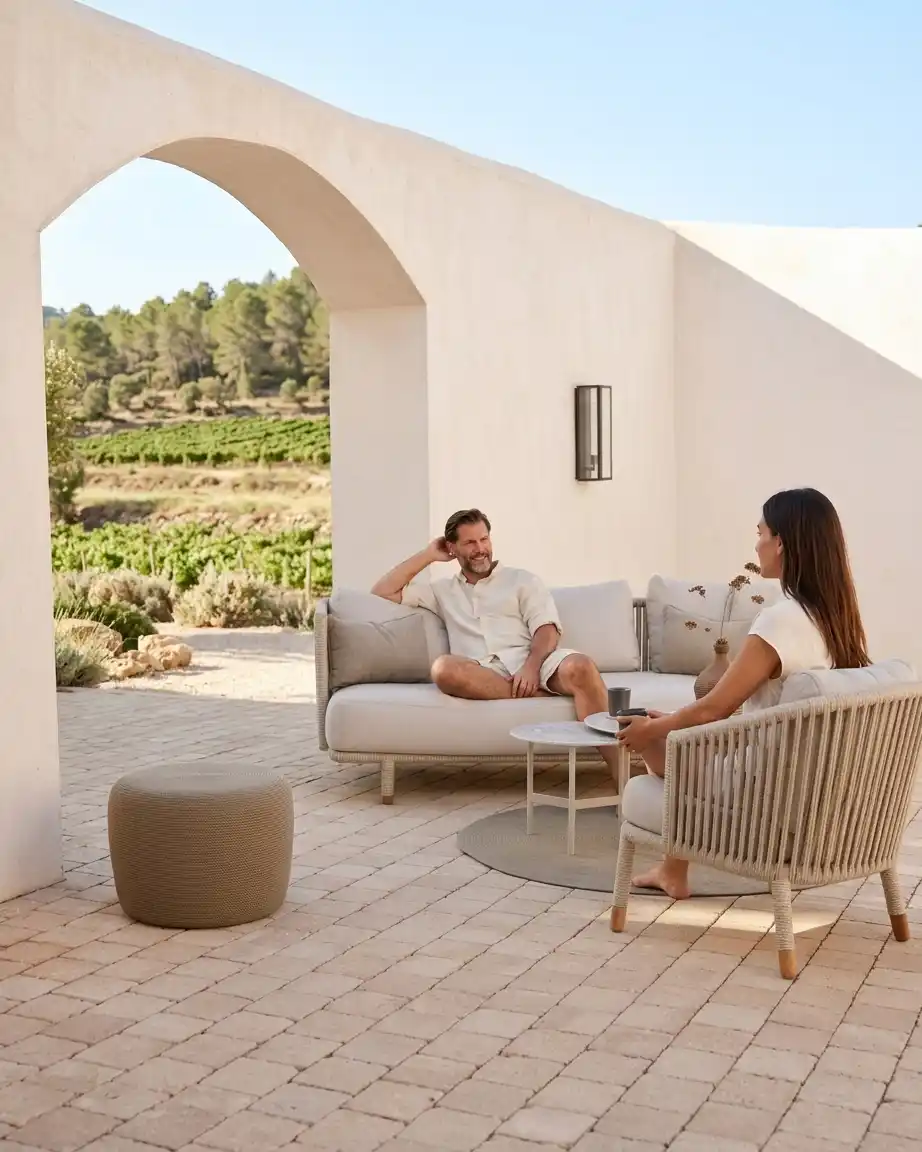 Side profile of the L shaped corner sofa highlighting the intricate rope weave and high-density waterproof beige cushions.
