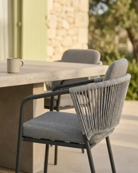 Luxury matte black marine-grade aluminium Solano vertical rope armchair with UV-stabilized cord for commercial outdoor dining sets.