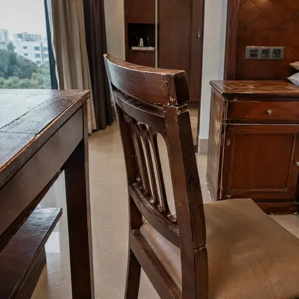 Kiln-dried solid teak dining chairs and tables manufactured for a restaurant in Raipur.